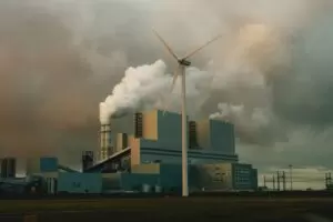 a factory with smoke billowing out of it's stacks